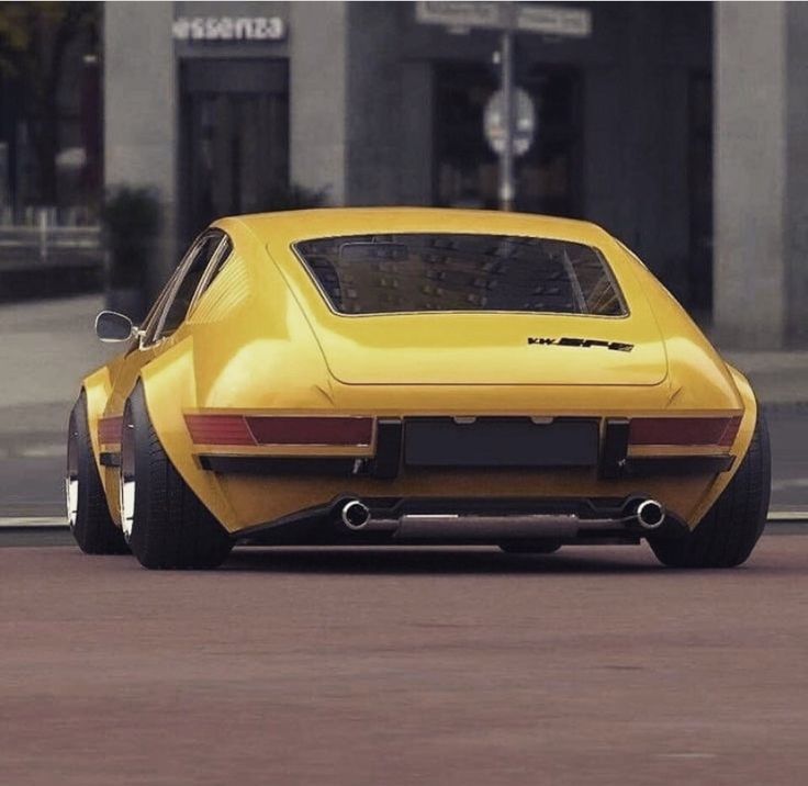 a yellow sports car is parked on the street