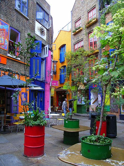 an alleyway with colorful buildings and trees