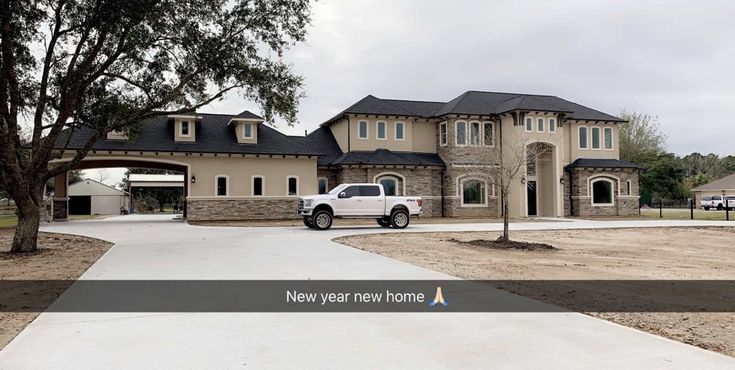 a white truck parked in front of a large house