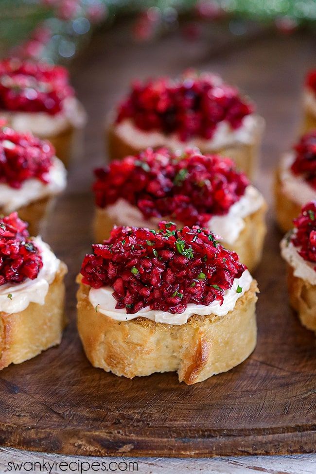 small cranberry and goat cheese appetizers on a wooden platter