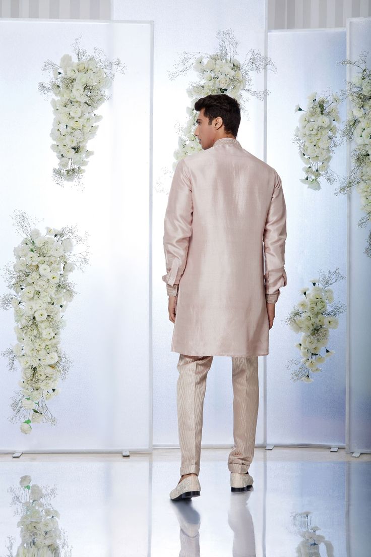 This rose gold silk kurta set features kiran dori embroidery on the collar, cuff and placket. It is paired with a jacquard trouser. Complimenting footwear is also available.From Seema Gujral's Tuscan Summer collection. DELIVERY TIMEPlease allow 8-12 weeks for your outfit to arrive.FABRIC DETAILSSilkProfessional cleaning only. Silk Sherwani Straight Kurta For Formal Occasions, Unstitched Silk Kurta For Formal Occasions, Semi-formal Sets With Zari Work For Eid, Festive Semi-formal Sets With Chikankari Embroidery, Formal Silk Kurta With Naqshi Detailing, Elegant Bandhgala With Self Design Straight Kurta, Formal Silk Bandhgala With Straight Kurta, Formal Bandhgala With Self Design In Straight Kurta Style, Silk Bandhgala Straight Kurta For Formal Occasions