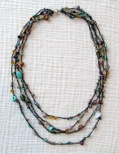 a multi strand beaded necklace with glass beads