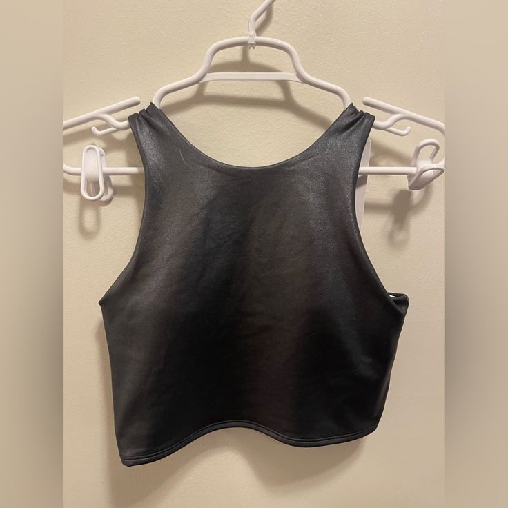 Nwt Shiny Black Crop Top Fits A-C Cup. Chest: 14” Length: 15.5” Trendy Fitted Sports Tank Top, Black Stretch Tank Top For Club, Stretch Black Tank Top For Club, Black Sporty Tank Crop Top, Sporty Black Tank Crop Top, Black Stretch Cropped Tank Top, Black Tank Crop Top For Sports, Black Tank Crop Top For Workout, Black Fitted Tank Top For Club