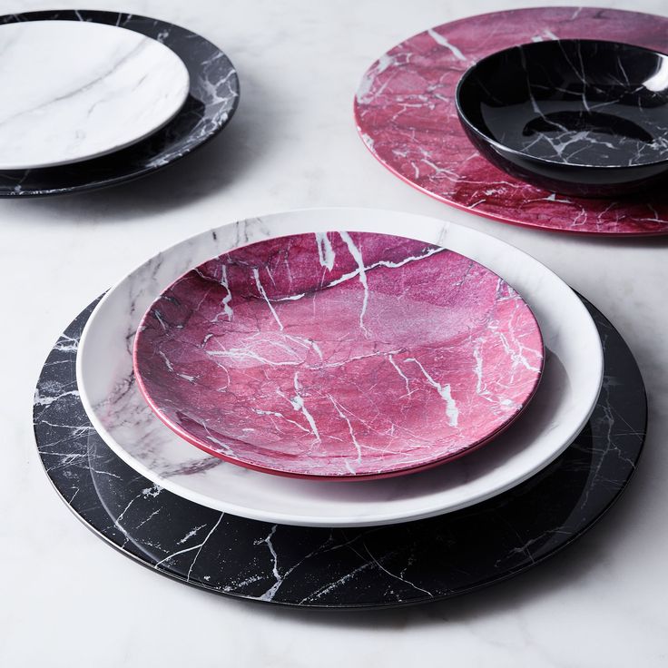 black and white plates with pink marble on them