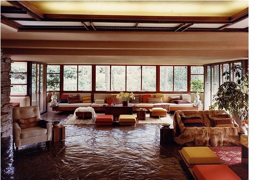 a living room filled with furniture and lots of windows