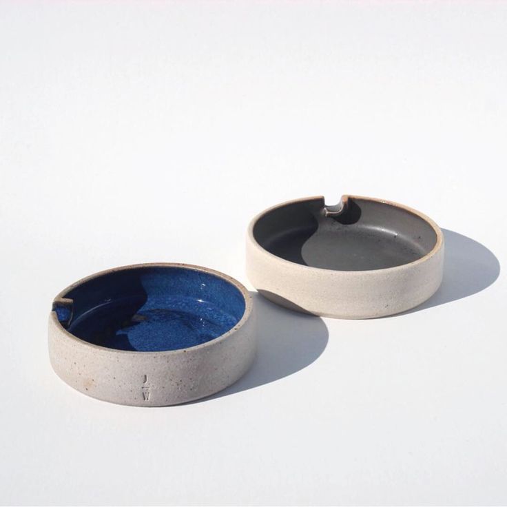 two white and blue bowls sitting on top of each other