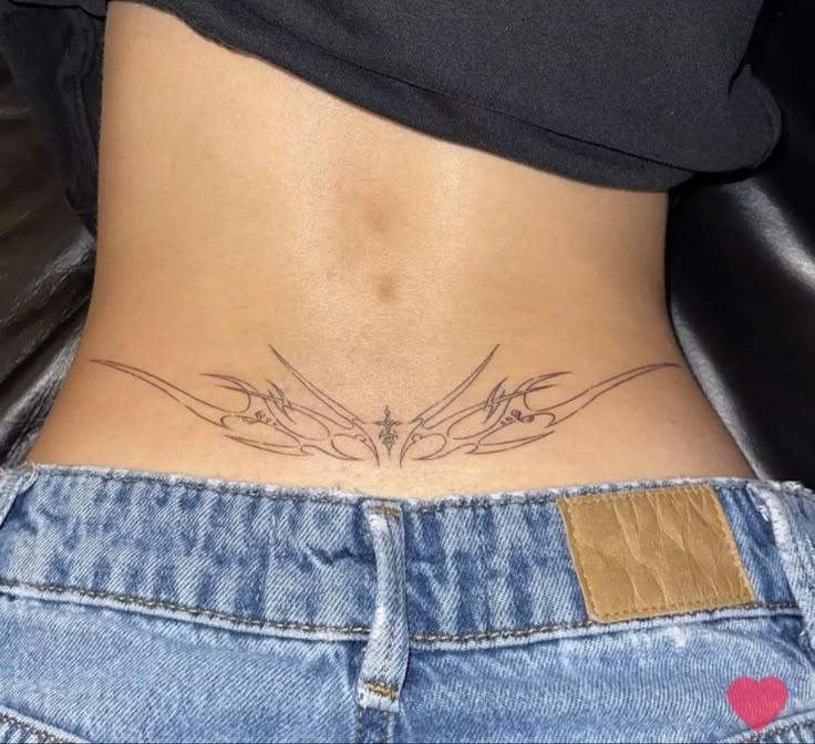 a woman's stomach with two birds tattoo on her lower back and the bottom