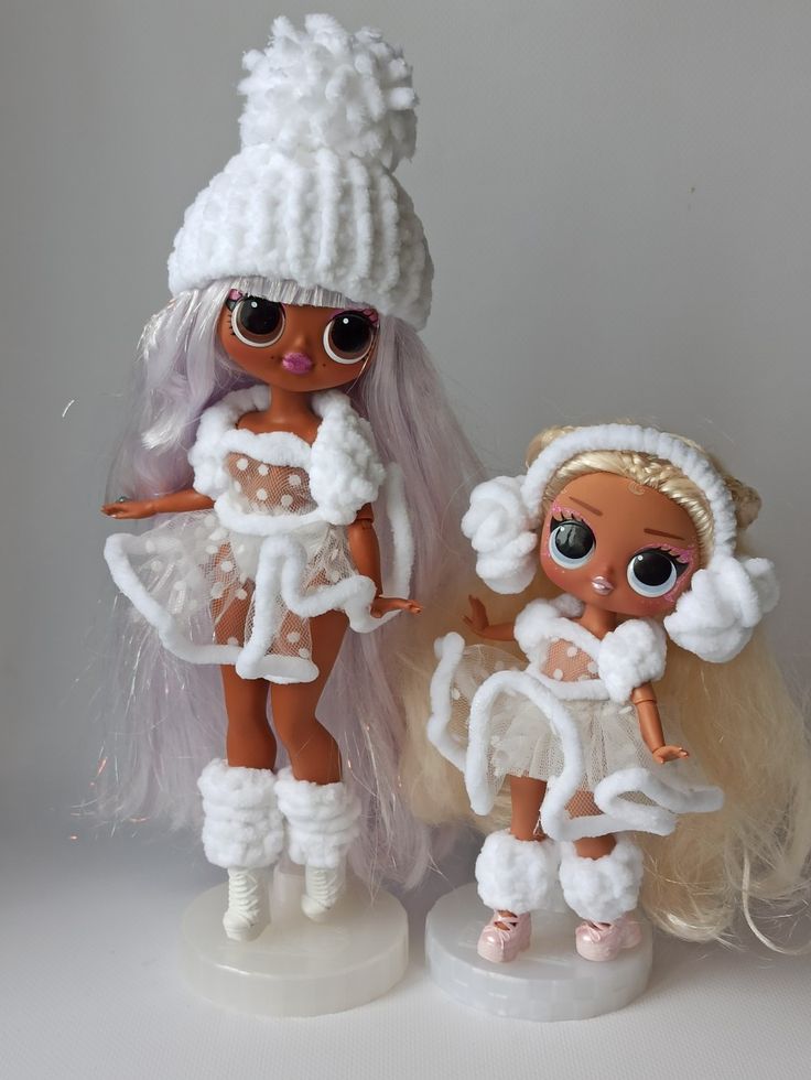 two dolls are dressed up in white outfits