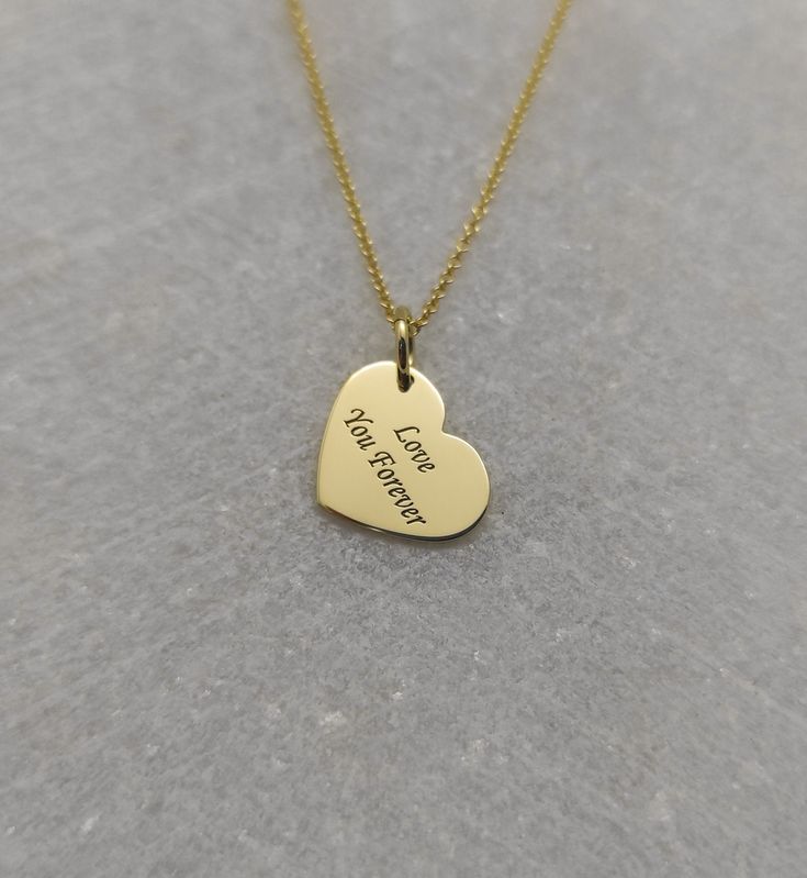 "Love You Necklace - Engraved Couples Charm - Gold Graduation Charm - Gold Heart Shape Pendant ▪️ A beautiful and clean engraved heart shaped pendant made out of 14K Solid Real Gold. Available in Yellow Gold, White Gold or Rose Gold finishes. Dimensions of the pendant - 1.3x0.9cm / 0.51x0.35 inches Necklace Length - You can choose your chain length from 35CM to 50CM. The pendant is available alone without a chain, select \"No Chain\" on the necklace length section. ▪️ We can engrave the back of 14k Gold Charm Necklaces For Anniversary, Valentine's Day, Engraved 14k Gold Heart Necklace For Valentine's Day, Engraved Heart Necklace In 14k Gold For Wedding, Engraved 14k Gold Heart Necklace For Wedding, Gold Heart Necklace For Valentine's Day Wedding Gift, Gold Heart Pendant Necklace As Wedding Gift, Gold Heart Necklace For Wedding Gift On Valentine's Day, Valentine's Day 14k Gold Engraved Heart Necklace, Gold Heart Necklace For Wedding And Valentine's Day