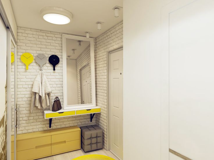 a white brick wall with yellow drawers and mirrors