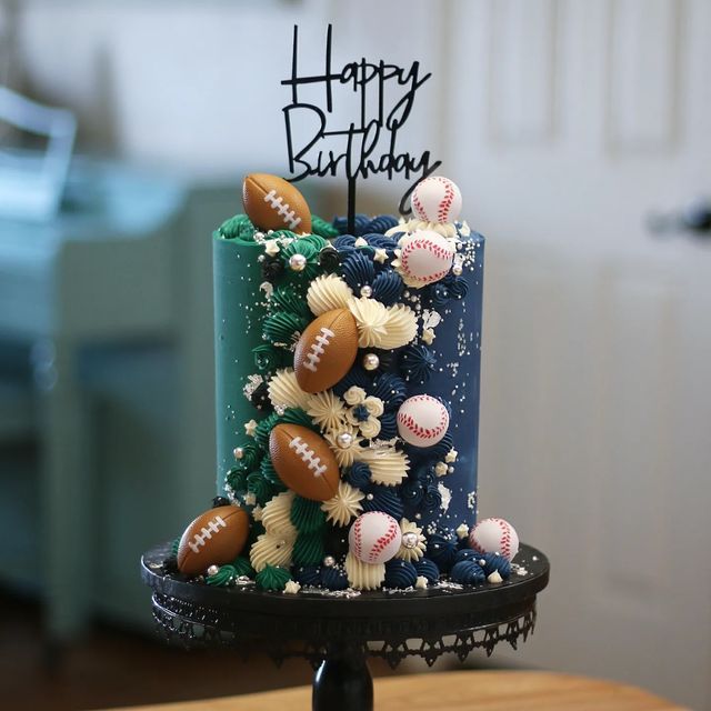 a birthday cake decorated with baseballs and shells on a table in a living room