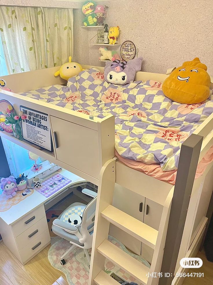 there is a bunk bed with a desk underneath it and stuffed animals on the wall