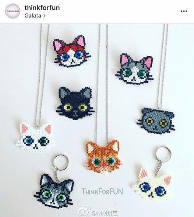 the beaded cats are hanging from the necklaces on the string, and they have different colors