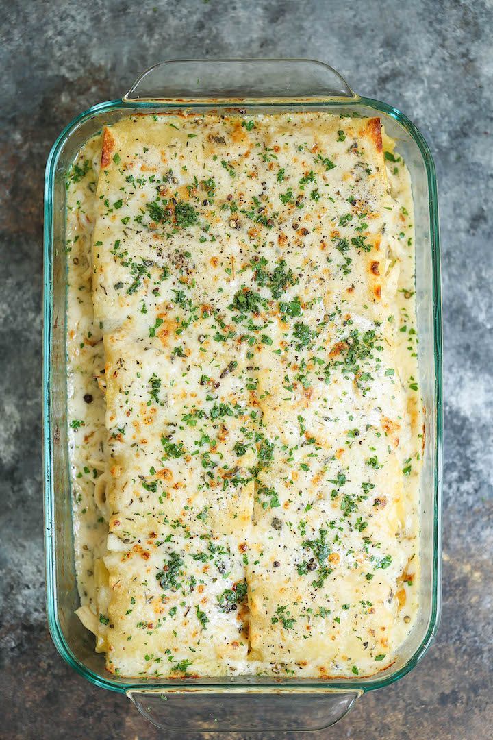 a casserole dish filled with cheese and herbs