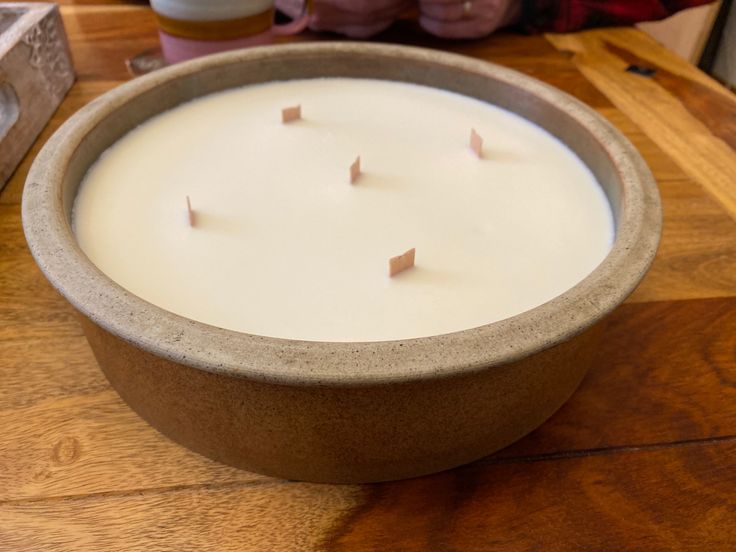 a candle that is sitting on a table next to a box with some candles in it