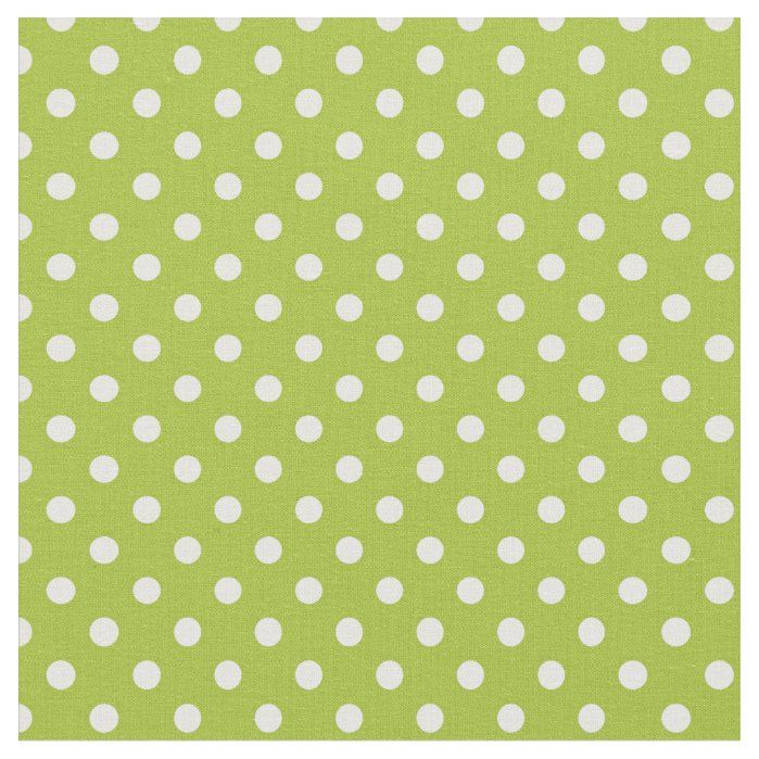 a green background with white polka dots