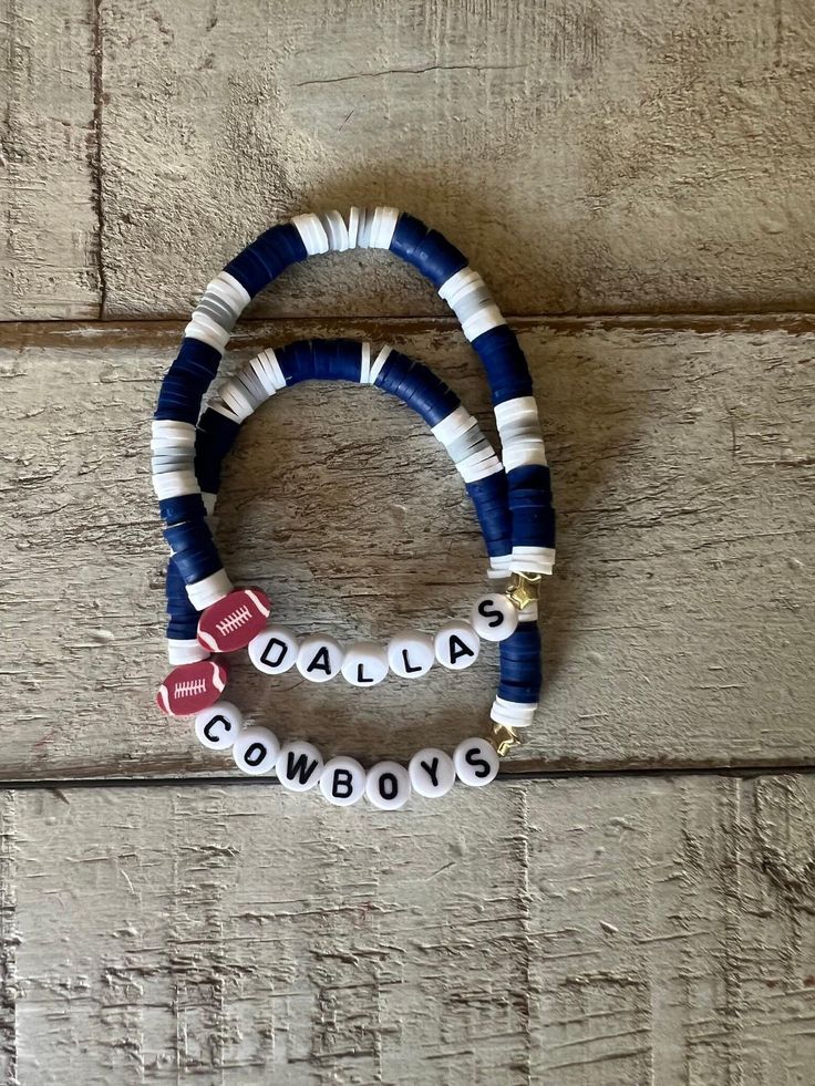 NFL Sports Clay Bracelet Stacks! Available in 2 stacks or  3 stacks. These bracelets are created with lightweight Heishi beads held together by strong durable elastic cord with the knot glued for extra durability. Completely customizable to you favorite NFL team!  In the personalization box list the NFL team you want , wording and charms you want for each band and I will match with the NFL colors!  Charms available include : Stars, hearts, footballs Gold or silver spacer ball beads  Letter colors available: Silver/ white letters , Black/white letters, Gold/white letters Reference for Adult sizes for bracelets: judge accordingly XS- 6.25' S- 6.50' Standard Adult 7' L- 7.50' XL- 8'  ** have questions and need help , please message me** ** Beads are small and can be choking hazards for small College Football Bracelets, Clay Bead Bracelet Ideas Football, Dallas Cowboys Bracelets, Adjustable Stacked Heishi Beads Stretch Bracelet, Sports Crafts To Sell, Nfl Bracelets, Nfl Colors, Dallas Cowboy Bracelet, Make Clay Beads