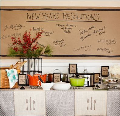 a table topped with lots of cups and saucers next to a wall covered in writing