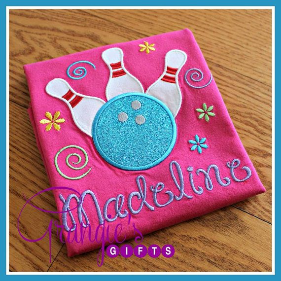 a pink t - shirt with a bowling ball and pins embroidered on the front that says, madelings gifts