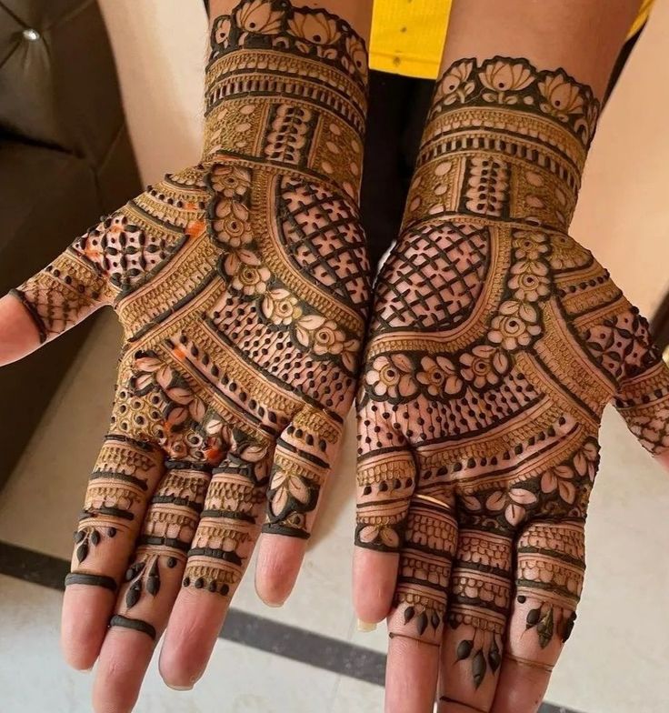 two hands with henna designs on them