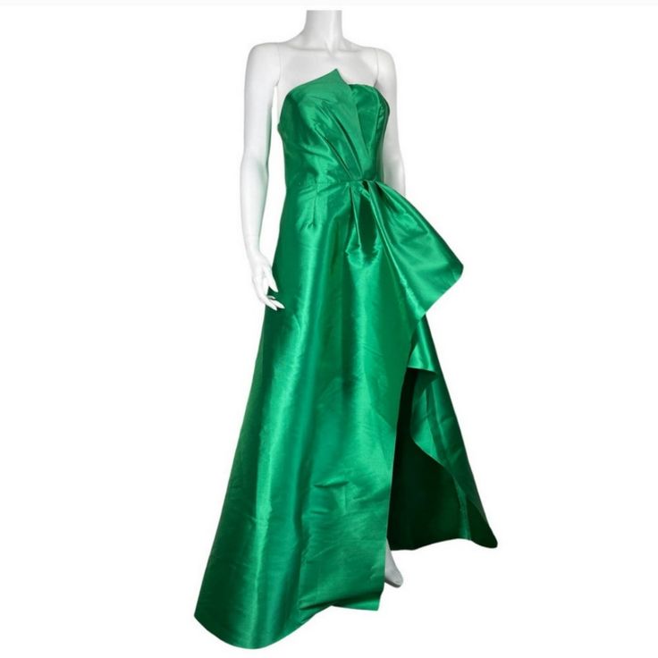 a mannequin wearing a green dress on a white background