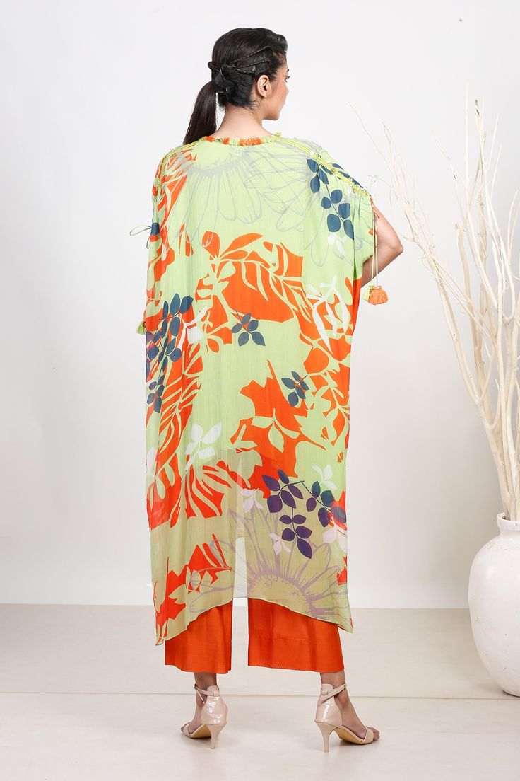 Green and orange chiffon kaftan with tasseled neckline and leaf print. Comes with pant.
Components: 2
Pattern: Printed
Type Of Work: Leaf
Neckline: Round
Sleeve Type: Half
Fabric: Chiffon
Color: Green, Orange
Other Details: 
Closure : Drawstrings
Occasion: Mehendi and Haldi - Aza Fashions Chiffon Kaftan, Orange Chiffon, Fashion App, Green Leaf, Pant Set, Leaf Print, Set For Women, Leaf Prints, Green Orange