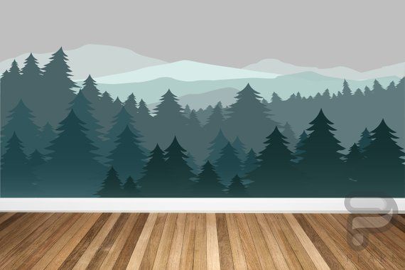 an empty room with wood flooring and a wall mural that has trees on it