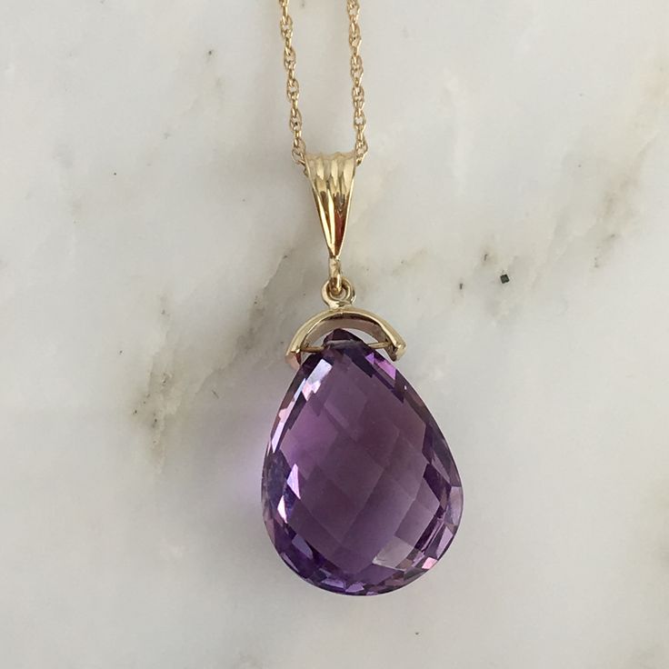 Details: Lovely vintage amethyst pendant and 14K gold necklace. The amethyst is faceted, and has an amazing sparkle glow. The amethyst measures 15.19 x 19.67 x 10.37mm, and is roughly 14.5 carats. This pendant is sold with a 14K gold chain, and the chain is modern. Please ask all necessary questions prior to placing an order! Size: The chain measures 16 inches, and the pendant is 1 1/4 inches. Condition: The overall all condition of this piece is very good. Purple Drop Necklace For Formal Occasions, Formal Purple Drop Necklace, Formal Purple 14k Gold Necklace, Classic Amethyst Purple Necklace, Classic Purple Amethyst Necklace, Formal Drop Amethyst Necklaces, Formal Amethyst Drop Necklace, Formal Drop Amethyst Necklace, Large Locket