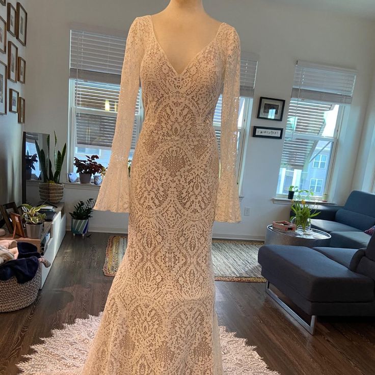 a wedding dress on display in a living room