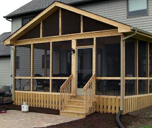 a house with screened porch and stairs leading up to the front door