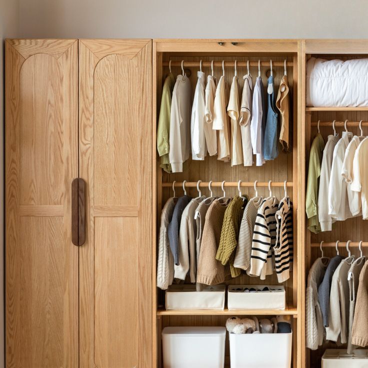 an organized closet with clothes and bins