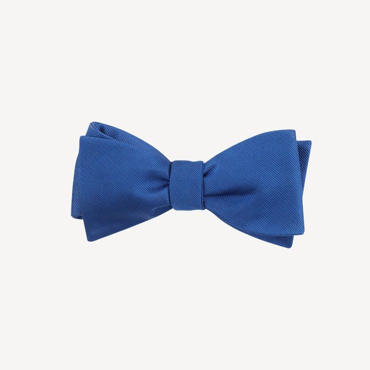 We've partnered with The Tie Bar to bring you this classic assortment of hand tied bowties in a variety of colors. Size is 2.5 in. wide x 58 in. long. Material: Handmade of 100% Silk Fabric Care: Imported, Dry-clean Only Detail: Hand Tied Classic Pre-tied Butterfly Knot Bow Tie, Blue Bow Tie With Butterfly Knot For Formal Events, Classic Pre-tied Satin Bow Tie, Classic Blue Suit And Tie Accessories For Summer, Classic Blue Tie With Butterfly Knot, Classic Solid Color Bow With Ties, Classic Bow With Butterfly Knot, Classic Adjustable Bow Ties, Business Tie With Butterfly Knot