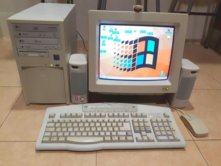 a desktop computer sitting on top of a tiled floor next to a keyboard and mouse