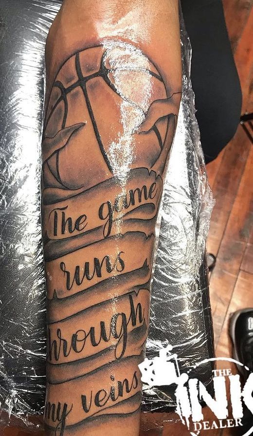 a man's arm with an inscription on it that says the game runs through my vein