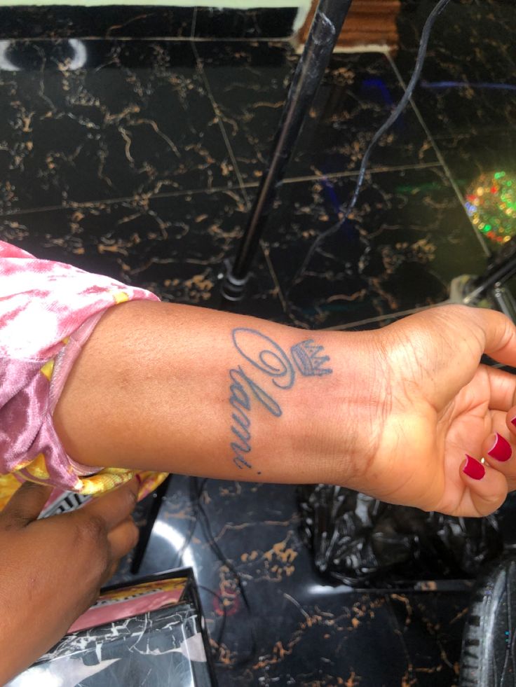 a woman's arm with a tattoo on it and the word love written in cursive writing