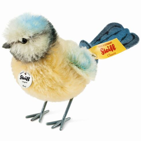 a small stuffed bird with blue feathers on it's head and feet, holding a tag in its beak