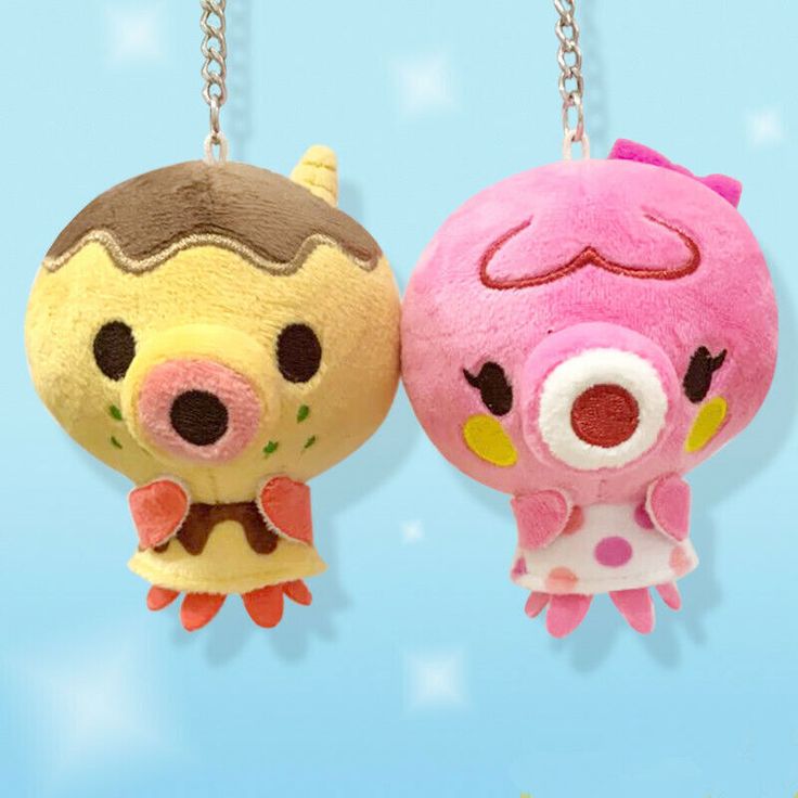 two small stuffed animals hanging from chains