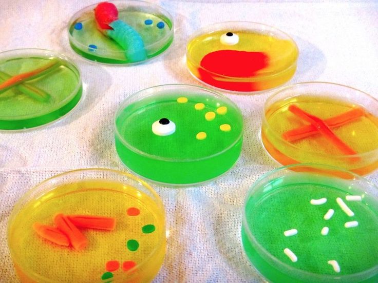 six plastic plates with different designs and colors on them sitting on a white table cloth