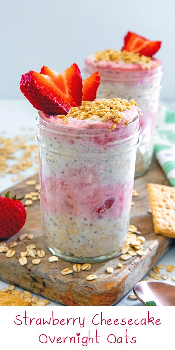 strawberry cheesecake overnight oats in mason jars with strawberries on top and crackers