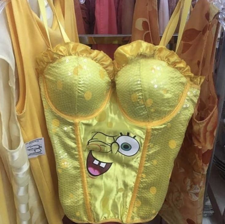 the spongebob bra is on display in front of other clothing and clothes racks