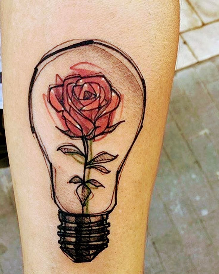 a rose in a lightbulb tattoo on the right leg, and an instagram page below