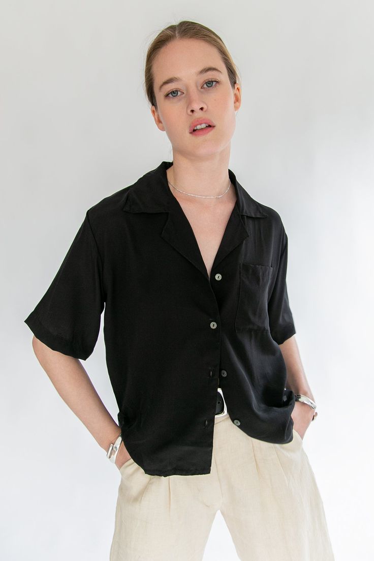 Named after the elegant Carmen Kass, comes the Kass top. This timeless silk button down is the perfect go to piece for your wardrobe. With an oversized fit, it the perfect mix of masculinity and femininity. Black - 100% Silk Crepe Dry Clean Only. Saiai is 5'8 / 172 cm and wearing a size 1 which is equivalent to a Small. Classic Viscose Tops With Button Closure, Formal Button-up Viscose Tops, Classic Collared Rayon Tops, Oversized Formal Tops With Lapel Collar, Collared Rayon Blouse For Work, Classic Tops With Lapel Collar For Day Out, Formal Collared Viscose Tops, Chic Viscose Button-up Shirt, Elegant Collared Rayon Blouse