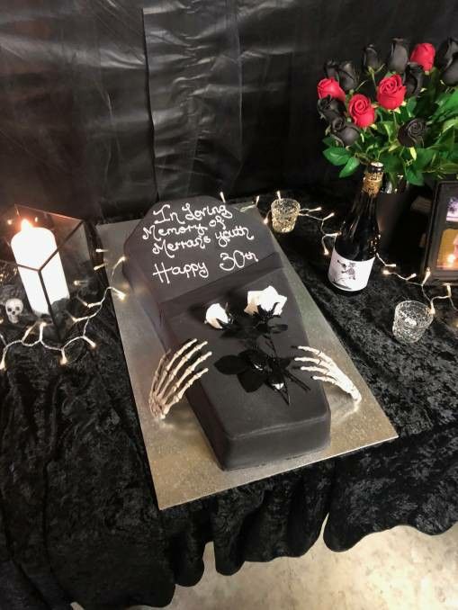 a birthday cake on a table with candles and flowers