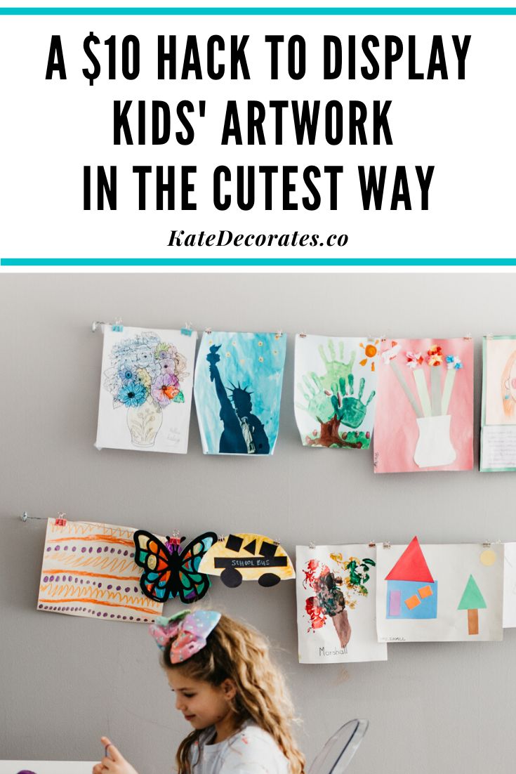 If you're wondering how to display kids wall art at home on the cheap, this quick, $10 wall art display hack is THE most genius solution. Never worry about how to display kids art again ... and your kids will be so thrilled to see all their gorgeous artwork displayed proudly in your home! #kidsdecor #kidsart #kidscrafts #kidsroom #kidsroomdecor #kidsartprojects #homedecor #easydiy Display Kids Artwork In Playroom, Kids Art Display Cable, Hanging Kids Artwork On The Wall, Cork Board Kids Art Display, Kid Art Work Display, Display Kids Artwork At Home, Kids Art Display Wall Hanging Artwork, How To Hang Kids Art On Wall, Display Childrens Artwork Home