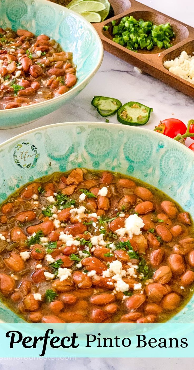 two bowls filled with beans and vegetables on top of a table