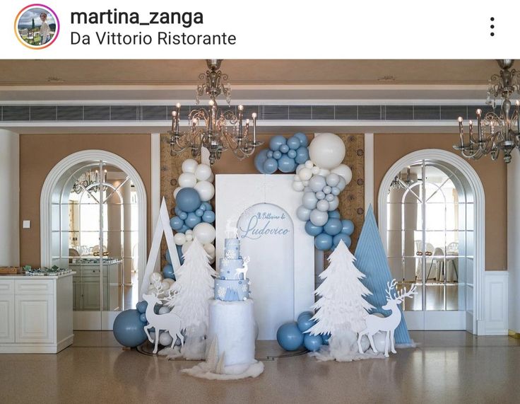 a room decorated with blue and white balloons