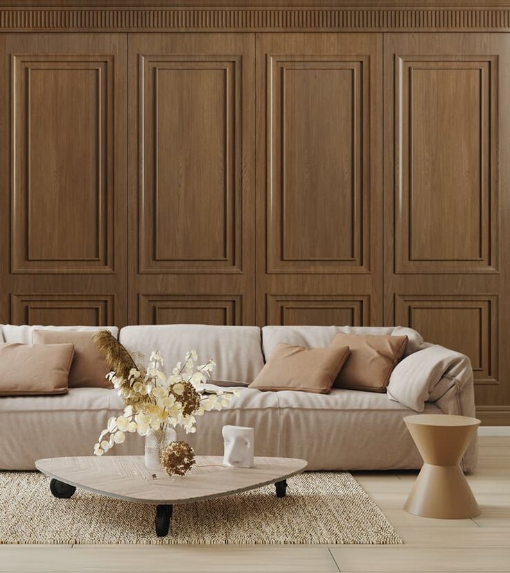 a living room filled with furniture and wooden paneled wall behind the couch is a coffee table