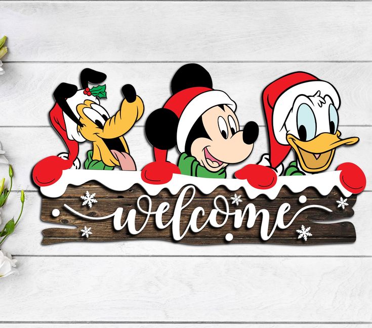 mickey mouse and donald duck welcome sign with snowflakes on the wood planks