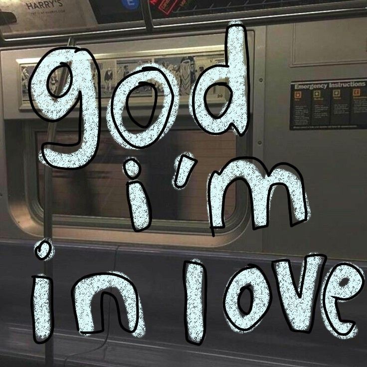 the words god i'm in love are painted on a subway car