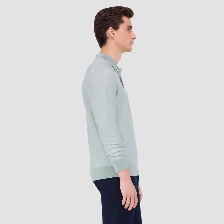 This premium knitwear polo sweater blends comfort and refinement. Made from extra fine Merino wool and silk, it offers unparalleled softness, warmth and a touch of opulence. The refined bird's eye jacquard stitch adds texture. Finished with a three button placket, solid polo collar, cuffs, and waistband. Dressed up for business meeting or down for a casual outing, this sweater exudes understated luxury and effortless style. Luxury Fine Knit Sweater For Formal Occasions, Luxury Merino Wool Sweater For Formal Occasions, Formal Fine Knit Merino Wool Sweater, Luxury Fine Knit Formal Sweater, Luxury Formal Fine Knit Sweater, Elegant Formal Polo Shirt With Ribbed Collar, Formal Wool Sweater With Ribbed Collar, Luxury Merino Wool Polo Sweater For Work, Formal Polo Collar Sweater For Winter